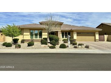 Charming single-story home with desert landscaping, a tile roof, and a two-car garage at 15960 W Bonitos Dr, Goodyear, AZ 85395