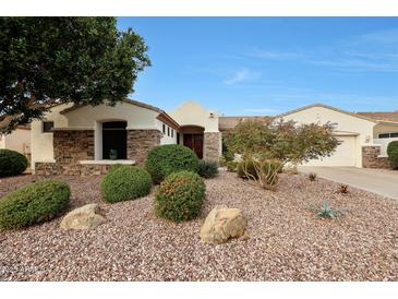 Landscaped front yard featuring stone accents and desert flora creates inviting curb appeal at 3134 N 145Th Ave, Goodyear, AZ 85395