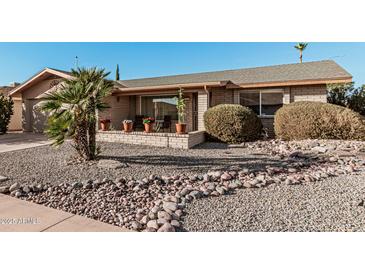 Charming home featuring rock landscaping, quaint front porch and appealing curb appeal at 7916 E Monte Ave, Mesa, AZ 85209