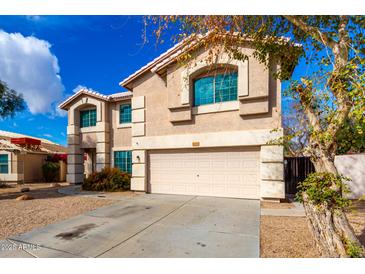 Two story home featuring an attached two car garage and well-kept yard at 8812 N 67Th Dr, Peoria, AZ 85345