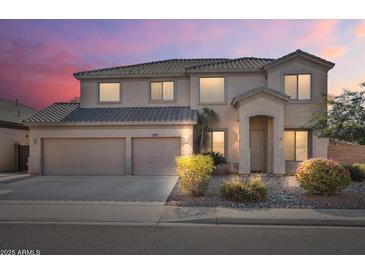 Charming two-story home with a three car garage and desert landscaping at 9237 W Alex Ave, Peoria, AZ 85382