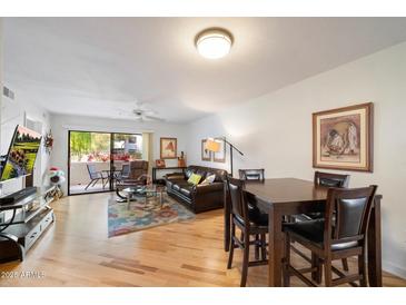 Open-concept living space connects the dining area, living room, and outdoor patio at 9990 N Scottsdale Rd # 1006, Paradise Valley, AZ 85253