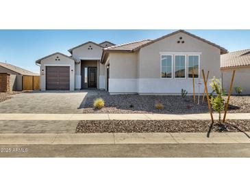 Charming single-story home with a well-manicured front yard and inviting entrance, creating a welcoming curb appeal at 1191 E Ridgerock St, Casa Grande, AZ 85122