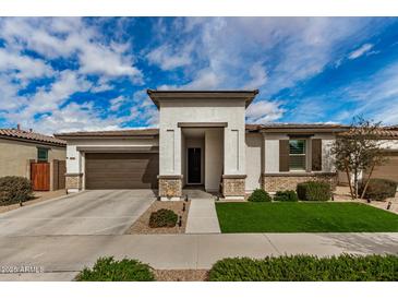 Charming single-story home featuring a well-manicured lawn, inviting entrance, and a two-car garage at 22864 E Via Del Sol --, Queen Creek, AZ 85142