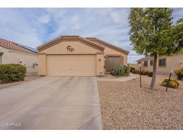 Charming single-story home with low-maintenance desert landscaping and an attached two-car garage at 233 N 21St St, Coolidge, AZ 85128