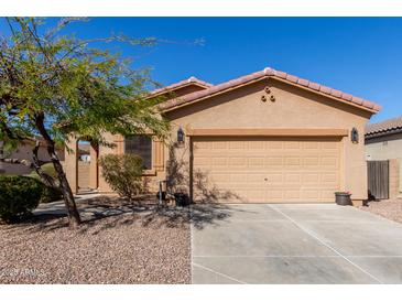 Charming single-story home features a desert landscape, two-car garage, and a classic Southwest design at 42578 W Rosalia Dr, Maricopa, AZ 85138