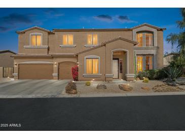 Stately two-story home featuring desert landscaping, a three car garage, and inviting front entry at 4502 E Night Owl Ln, Cave Creek, AZ 85331