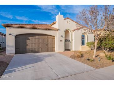 Charming home features a two-car garage, gated front entrance, and a well-maintained, low maintenance yard at 518 E Laddoos Ave, Queen Creek, AZ 85140