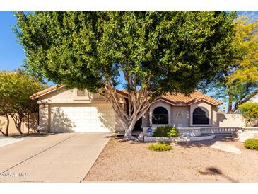 Charming single-story home featuring a well-maintained yard and a two-car garage at 5802 E Fountain St, Mesa, AZ 85205