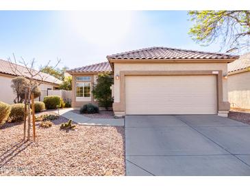 Charming single-Gathering home features a neutral-colored exterior and a well-maintained front yard with desert landscaping at 653 S Catalina St, Gilbert, AZ 85233