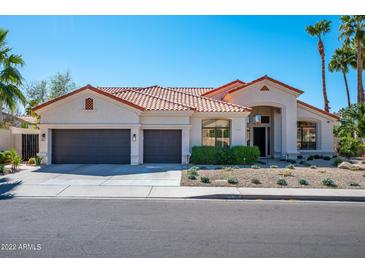 Charming single-story home with a three-car garage and desert landscaping at 9246 N 108Th St, Scottsdale, AZ 85259