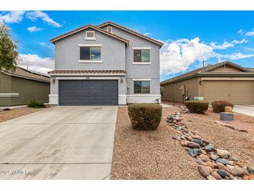 Two-story gray home featuring desert landscaping, a gray garage door, and a red tile roof at 1585 E Jeanne Ln, San Tan Valley, AZ 85140