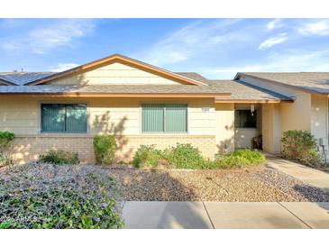 Charming single-story home featuring well-maintained landscaping and neutral color scheme at 18655 N Palomar Dr, Sun City West, AZ 85375