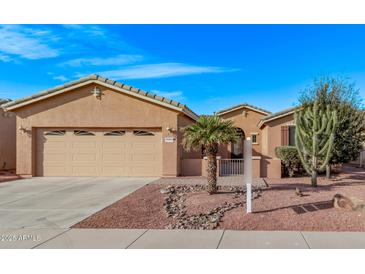 Charming single-story home features a low-maintenance desert landscape and a two-car garage at 20934 N Sweet Dreams Dr, Maricopa, AZ 85138