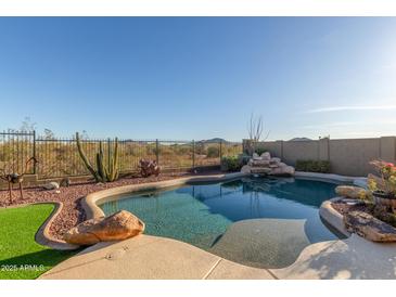 Enjoy this backyard pool with desert landscaping and a stone waterfall feature at 2815 W Adventure Dr, Anthem, AZ 85086