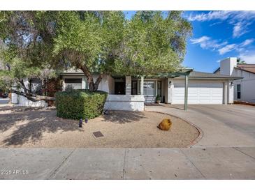 Charming single-story home featuring a well-maintained front yard and a two-car garage at 5532 W Onyx Ave, Glendale, AZ 85302