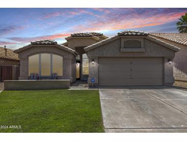 Charming single-story home with desert landscaping, tile roof, and welcoming curb appeal at 9853 W Tonopah Dr, Peoria, AZ 85382