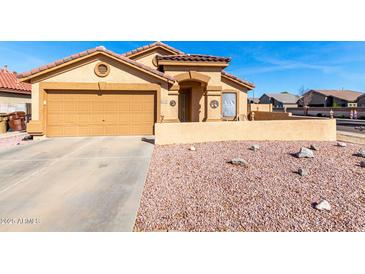 Charming single-story home with a two-car garage, neutral stucco, and desert landscaping at 10510 W Louise Dr, Peoria, AZ 85383