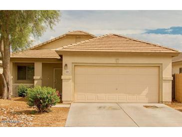 Charming single-story home with a two-car garage and well-maintained landscaping at 11206 W Granada Rd, Avondale, AZ 85392