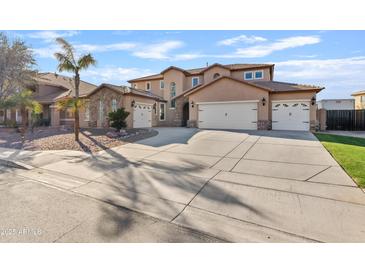 Expansive two-story home featuring desert landscaping, multiple garage spaces and a large driveway at 11405 E Rafael Ave, Mesa, AZ 85212