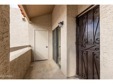 View of the outdoor patio with sliding glass door and extra storage area at 11666 N 28Th Dr # 234, Phoenix, AZ 85029