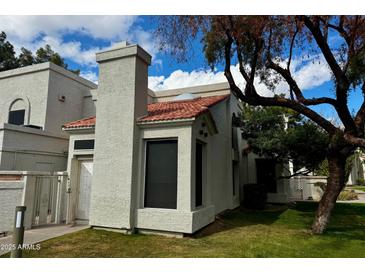 Charming home features stucco siding, red tile roof, and well-manicured lawn at 1717 E Union Hills Dr # 1065, Phoenix, AZ 85024