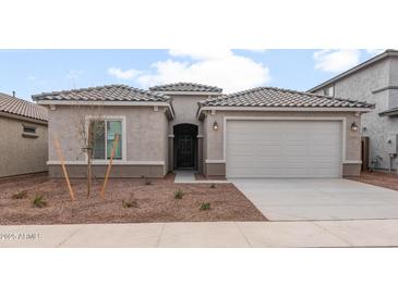 Charming single-story home with a two-car garage and low maintenance desert landscaping at 17843 W Encinas Ln, Goodyear, AZ 85338