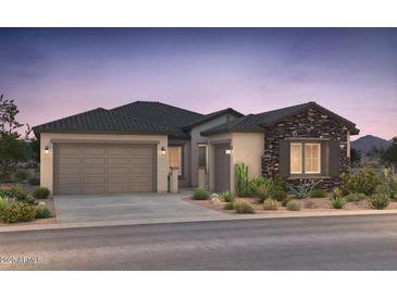 Charming single-story home with a three-car garage, stone accents, and desert landscaping at 18159 E Colt Dr, Queen Creek, AZ 85142