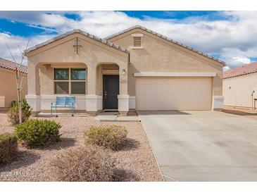 Charming single-story home featuring a two-car garage, covered entryway, and low-maintenance landscaping at 28916 N Selenite Ln, San Tan Valley, AZ 85143