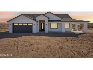 Beautiful single-story home featuring modern architecture and a neutral color palette and a 2 car garage at 35597 W Jones Ave, Tonopah, AZ 85354