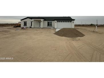 New construction home featuring a modern design with a white exterior and a symmetrical front facade at 36253 W Jefferson St, Tonopah, AZ 85354