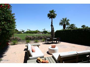 Inviting patio with comfortable seating, dining area, and golf course views at 4621 N 65Th St # 152, Scottsdale, AZ 85251