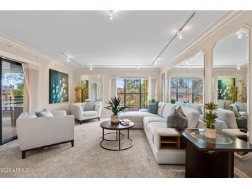 Bright living room with white furniture, modern decor, and large windows providing natural light at 5132 N 31St Way # 144, Phoenix, AZ 85016