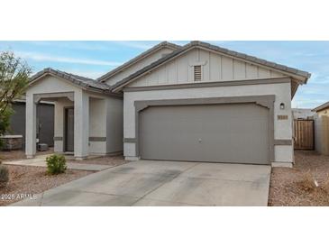 Charming single-story home with a two-car garage and well-maintained front yard at 9509 W Illini St, Tolleson, AZ 85353