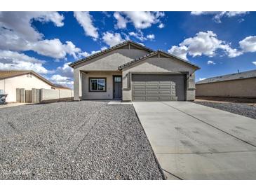 Charming single-story home featuring a two-car garage and low-maintenance gravel landscaping at 14951 S Capistrano Rd, Arizona City, AZ 85123
