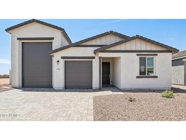 Charming single-story home featuring a three-car garage and desert landscaping at 15765 W Cheryl Dr, Waddell, AZ 85355