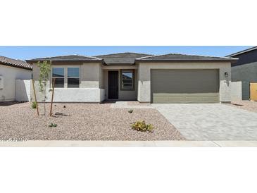 Charming single-story home featuring a low-maintenance desert landscape and a spacious two-car garage at 15778 W Cheryl Dr, Waddell, AZ 85355
