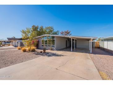 Charming single story home with covered parking and low-maintenance landscaping at 1660 W 7Th Pl, Mesa, AZ 85201