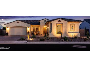 Charming single-story home with desert landscaping and inviting front porch with ample lighting at 2535 E Thornton Ct, Gilbert, AZ 85297