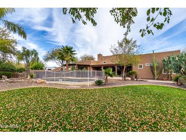 Expansive backyard with pool, mature landscaping, and privacy, perfect for outdoor entertaining at 38408 N 23Rd Dr, Phoenix, AZ 85086