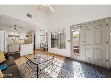 Bright living room showcasing an open floor plan, with kitchen, dining area, and patio access at 602 N May St # 29, Mesa, AZ 85201