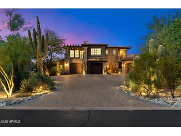 Stunning two-story home with a grand driveway, desert landscaping, and a three-car garage at 9290 E Thompson Peak Pkwy # 470, Scottsdale, AZ 85255