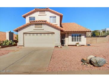 Charming home with a two-car garage, tile roof, and desert landscaping at 1314 E Bluefield Ave, Phoenix, AZ 85022