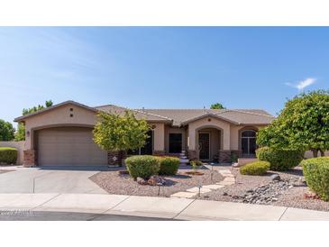 Charming single-story home featuring a neutral stucco exterior, well-manicured landscaping, and a two-car garage at 1544 N Rico Cir, Mesa, AZ 85213