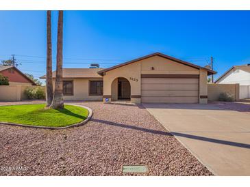 Charming single-story home featuring desert landscaping, a two-car garage and neutral toned exterior paint at 5123 E Beck Ln, Scottsdale, AZ 85254