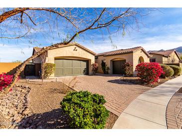 Charming single-story home featuring a brick driveway, two-car garage, and well-maintained landscaping at 9013 S 15Th Way, Phoenix, AZ 85042