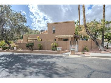 Charming desert home featuring stucco walls, lush landscaping, and a private gated entrance at 10432 N 7Th Pl # 1, Phoenix, AZ 85020