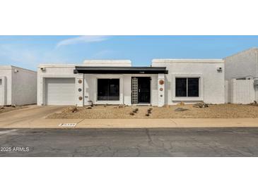 Charming single-story home with a desert-landscaped front yard and a bright white exterior at 1108 E Villa Rita Dr, Phoenix, AZ 85022