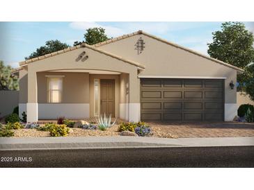 Charming single-story home featuring a two-car garage and low-maintenance desert landscaping at 129 S 176Th Dr, Goodyear, AZ 85338