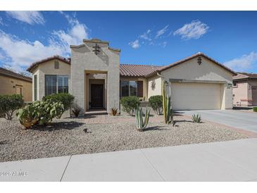 Charming single-story home featuring desert landscaping, a two-car garage, and a welcoming front entry at 16712 S 175Th Ln, Goodyear, AZ 85338